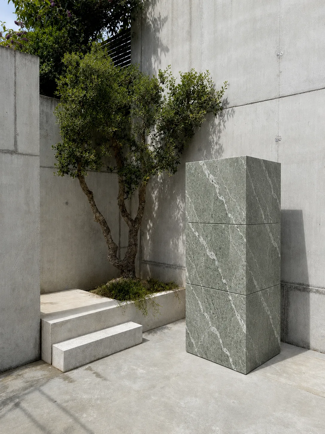 RO. stacked module in veined natural stone next to a concrete bench