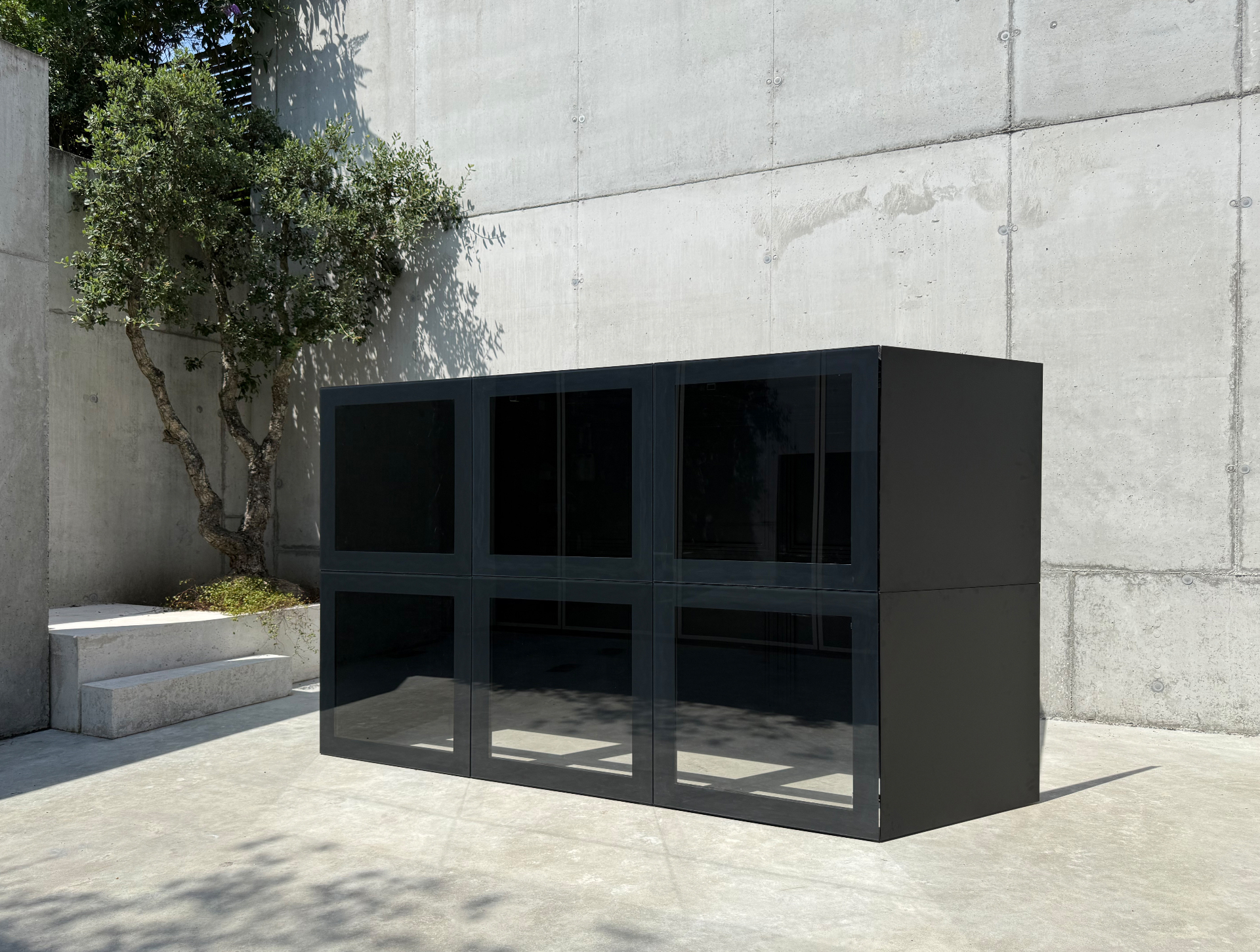 RO. modular composition with transparent glass panels in a refined black frame
