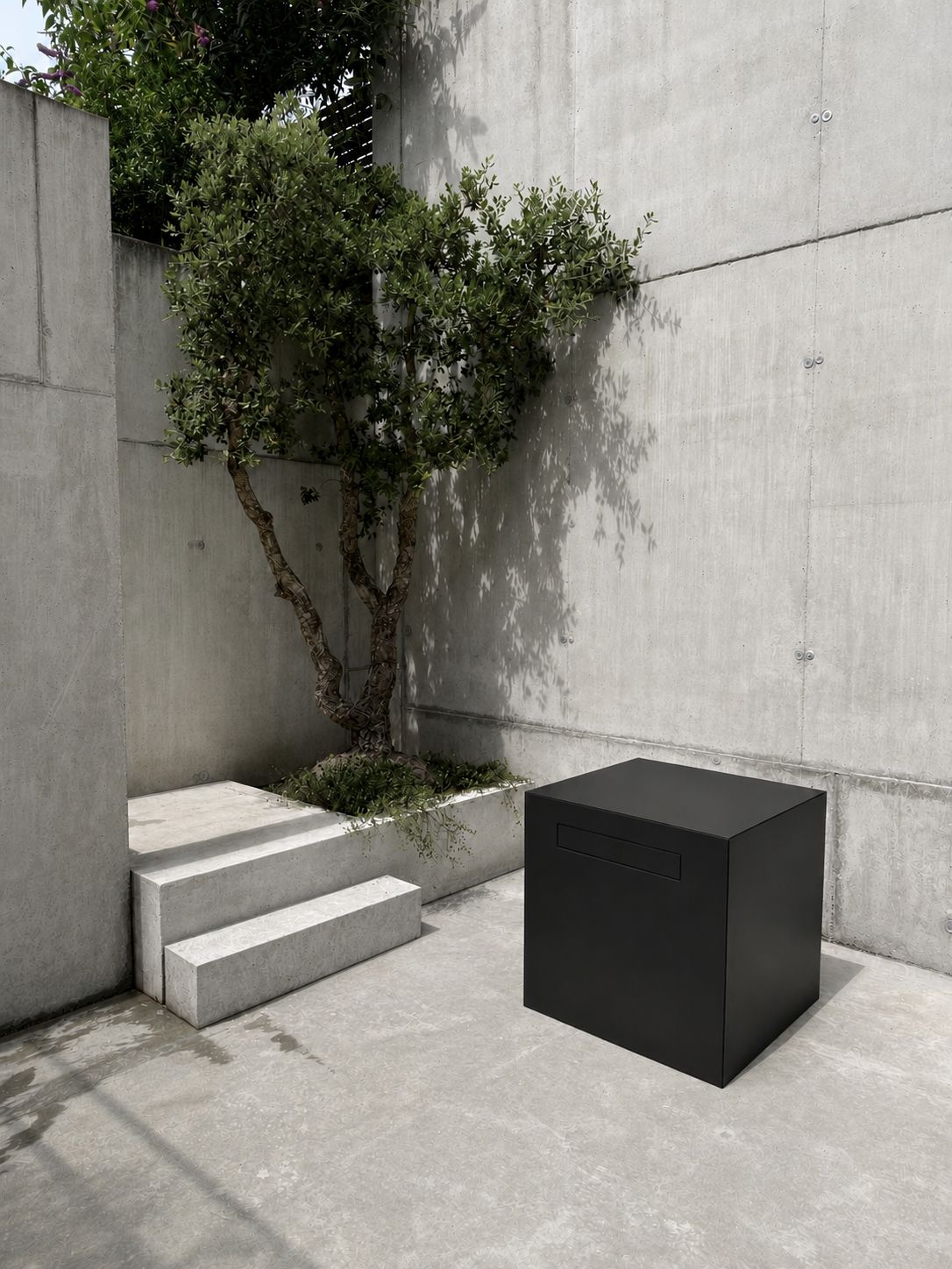 RO. parcel module · closed black aluminium cube next to a concrete bench